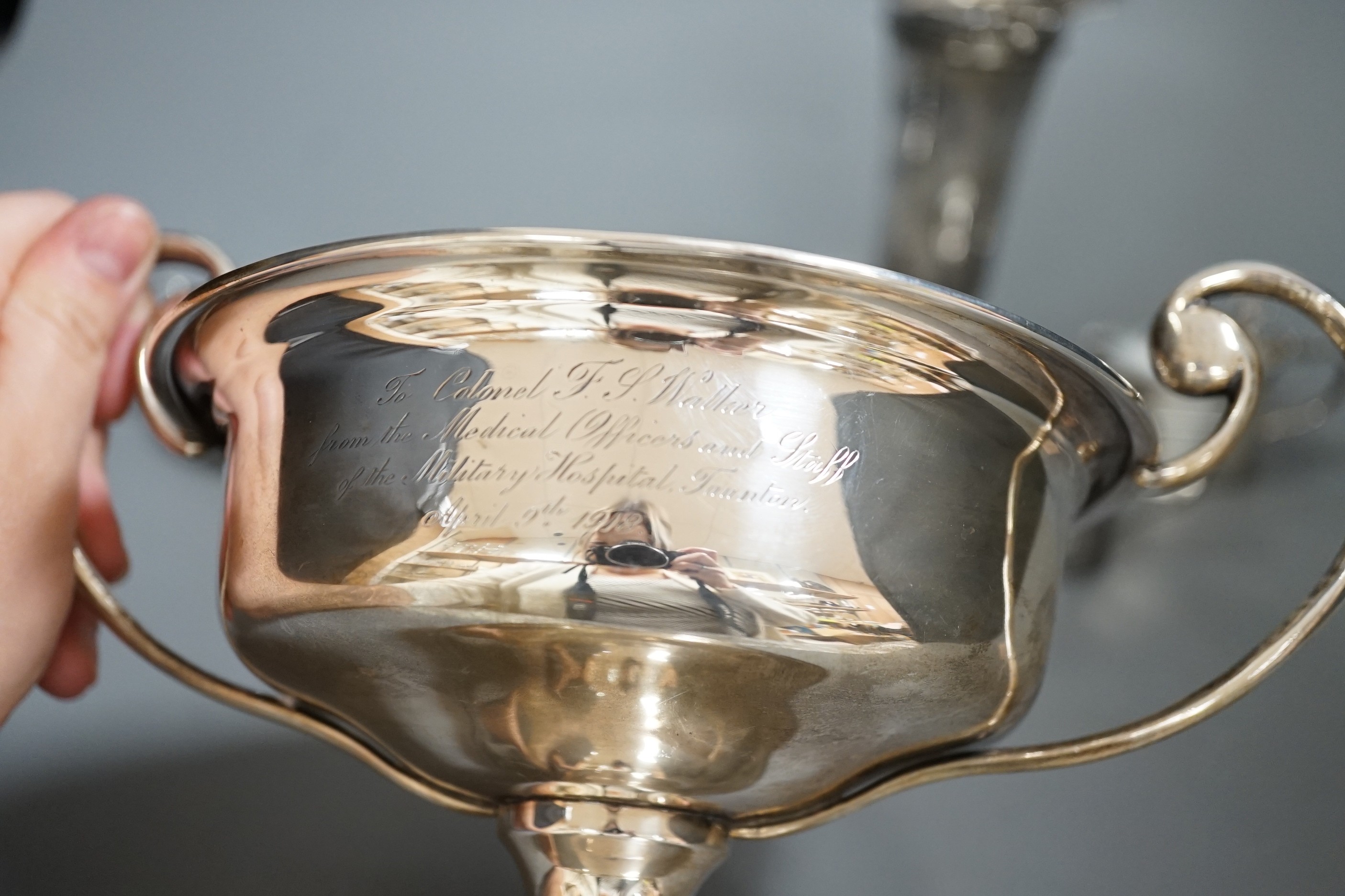 A group of assorted small silver items to include a posy vase, silver-mounted cut glass quaich, a twin-handled silver cup and three condiments.